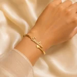Gold customized name kada bracelet worn on a female wrist