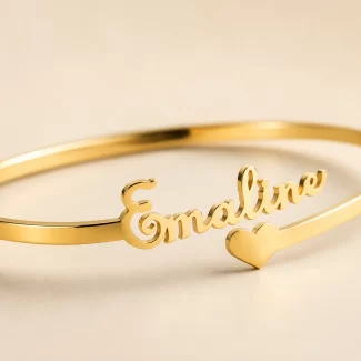 Close-up of customized gold name kada with Emaline script and heart