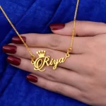 Crown Name Necklace Riya – female hand lifestyle