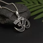 Black and Silver Om Pendant on black stone