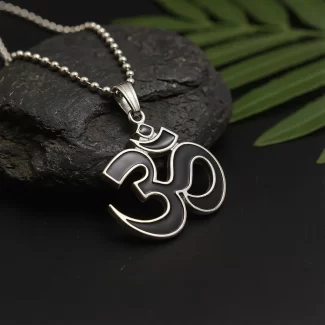 Black and Silver Om Pendant on black stone