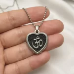 Black Om Heart Pendant hand-held detail view