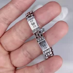 Crystal Om Silver Bracelet held in hand close-up