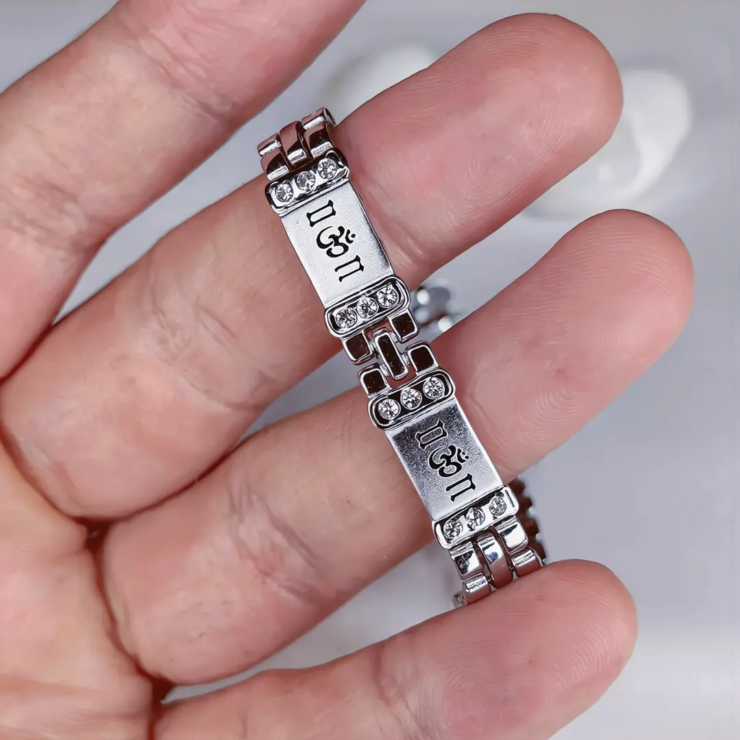 Crystal Om Silver Bracelet held in hand close-up