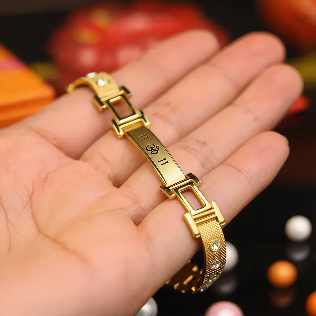 Gold Om Men Diamond Bracelet held in hand close-up