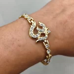 Gold Plated Om Diamond Bracelet held in hand close-up