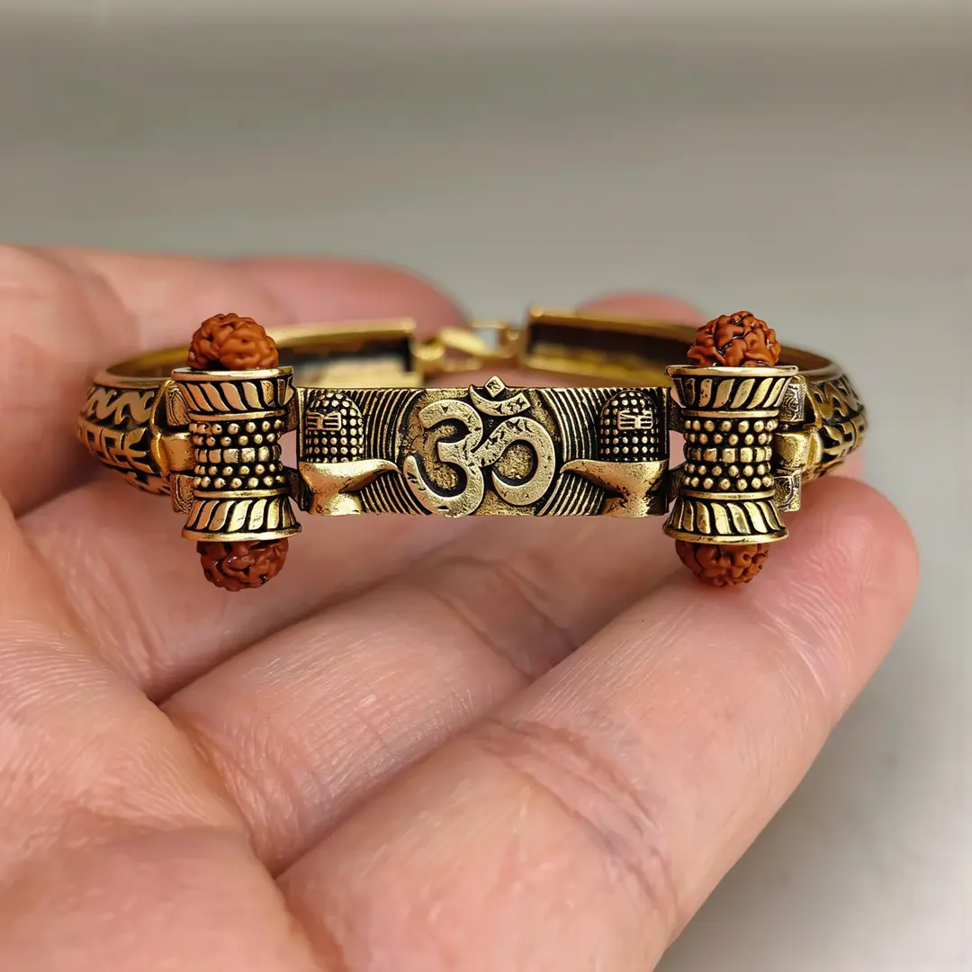 Gold Plated Shivlinga Om Trishul Rudraksha Bracelet held in hand close-up