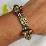 Gold Plated Shivlinga Om Trishul Rudraksha Bracelet worn on a men's wrist
