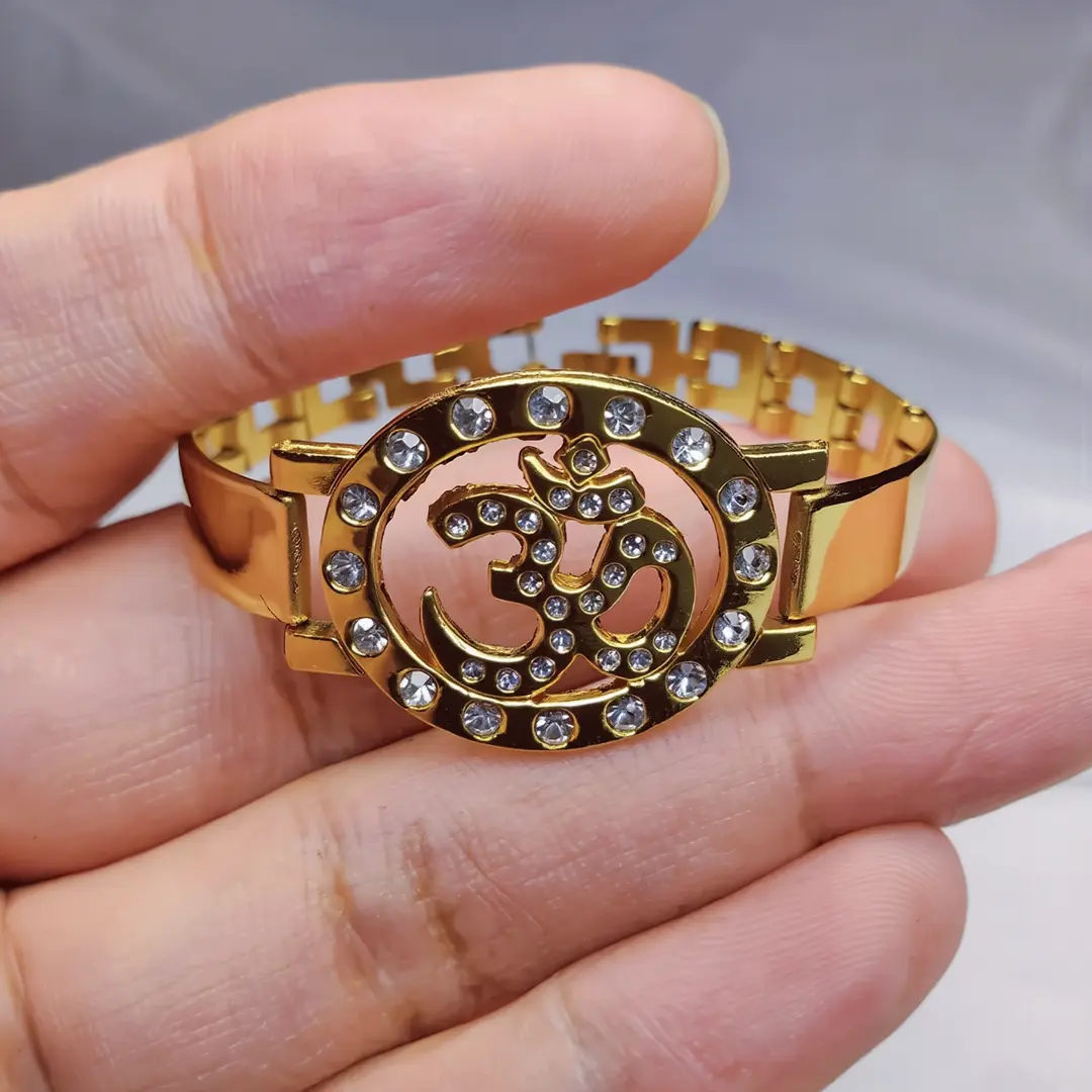 Om Gold Plated Beaded Bracelet held in hand close-up