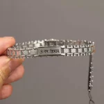 Stainless Steel Om Namah Shivay Bracelet held in hand close-up
