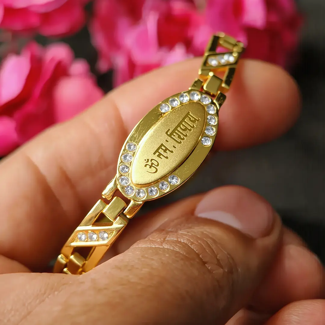 Gold Plated Om Namah Shivay Diamond Bracelet held in hand close-up