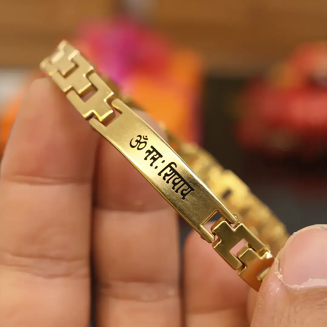Om Namah Shivay Gold Bracelet held in hand close-up