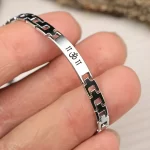 Om Silver Steel Bracelet hand-held detail view