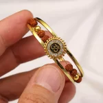 Om Sun Cuff Kada Bracelet with Rudraksh and Crystal for Men held in hand close-up