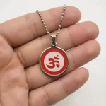 Red Om Pendant hand-held detail view