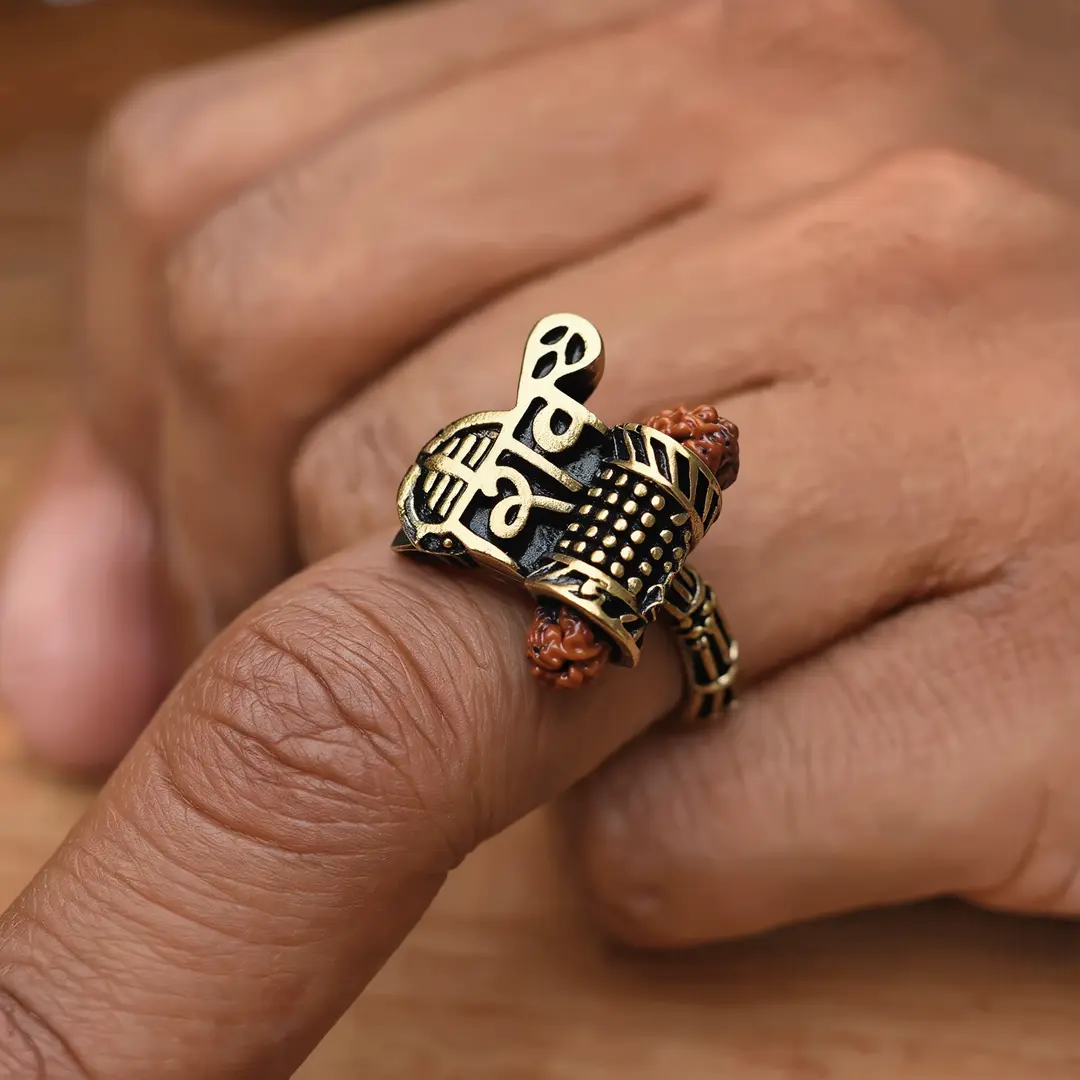 Shiv Rudraksha Rose Gold Plated Ring โ worn Shiv Rudraksha Rose Gold Plated Ring worn on a men's finger