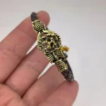 Gold Plated Simba Rudraksh Trishul Leather Bracelet hand-held detail view