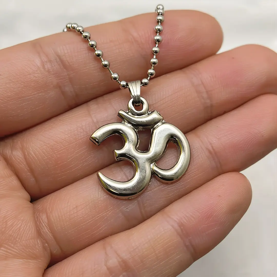 Antique Finish Om Pendant with Chain hand-held detail view Antique Finish Om Pendant with Chain hand-held detail view