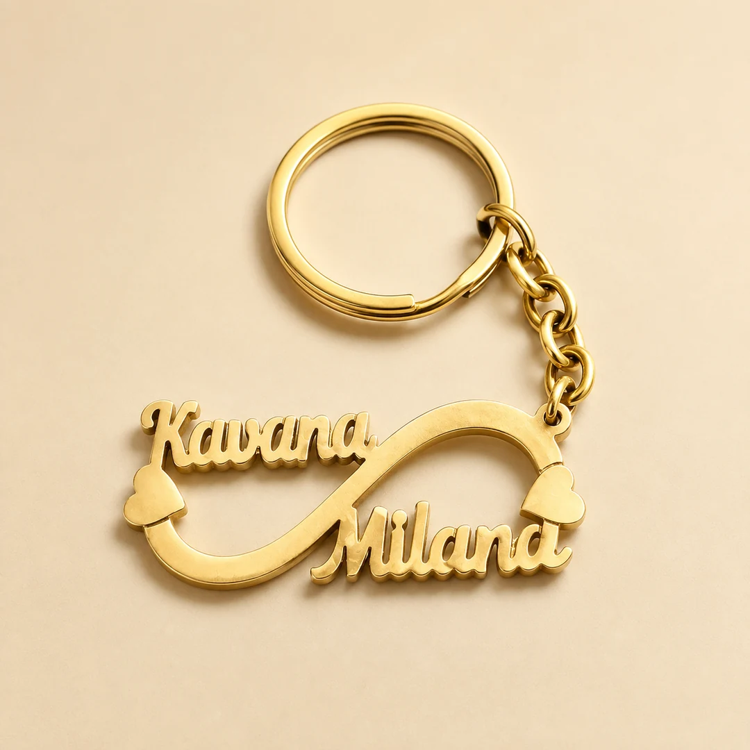 Double Name Infinity Keychain in gold brass on an ivory studio background